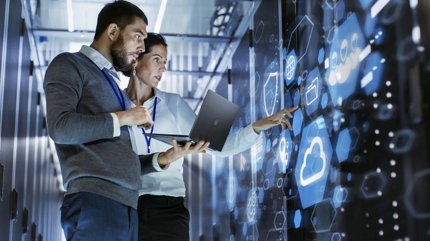 Technology professionals collaborating at a digital display